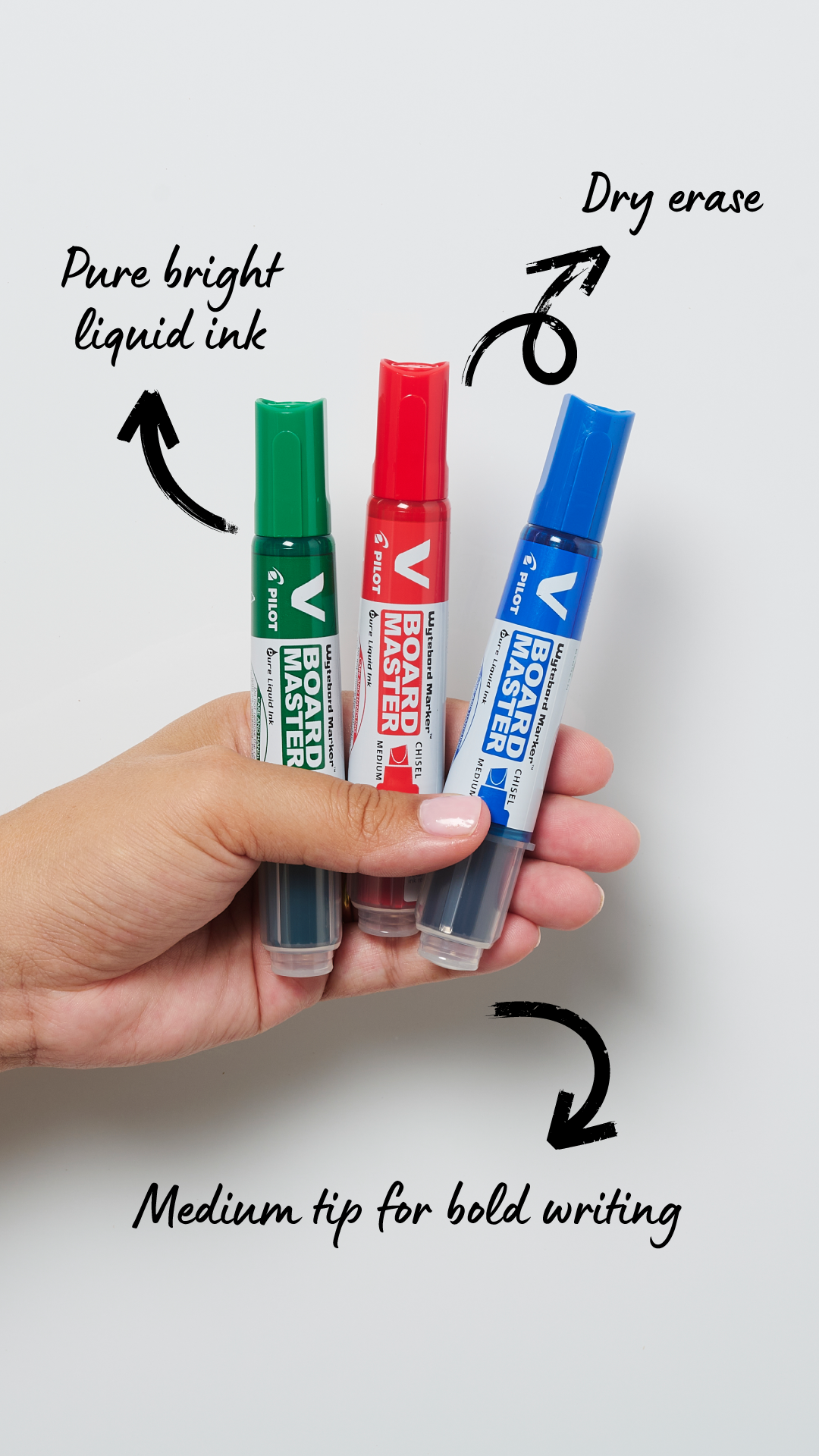 Close up of a blue, green and red V Board whiteboard markers held by a teacher with bright liquid ink and medium tips for clean erasing