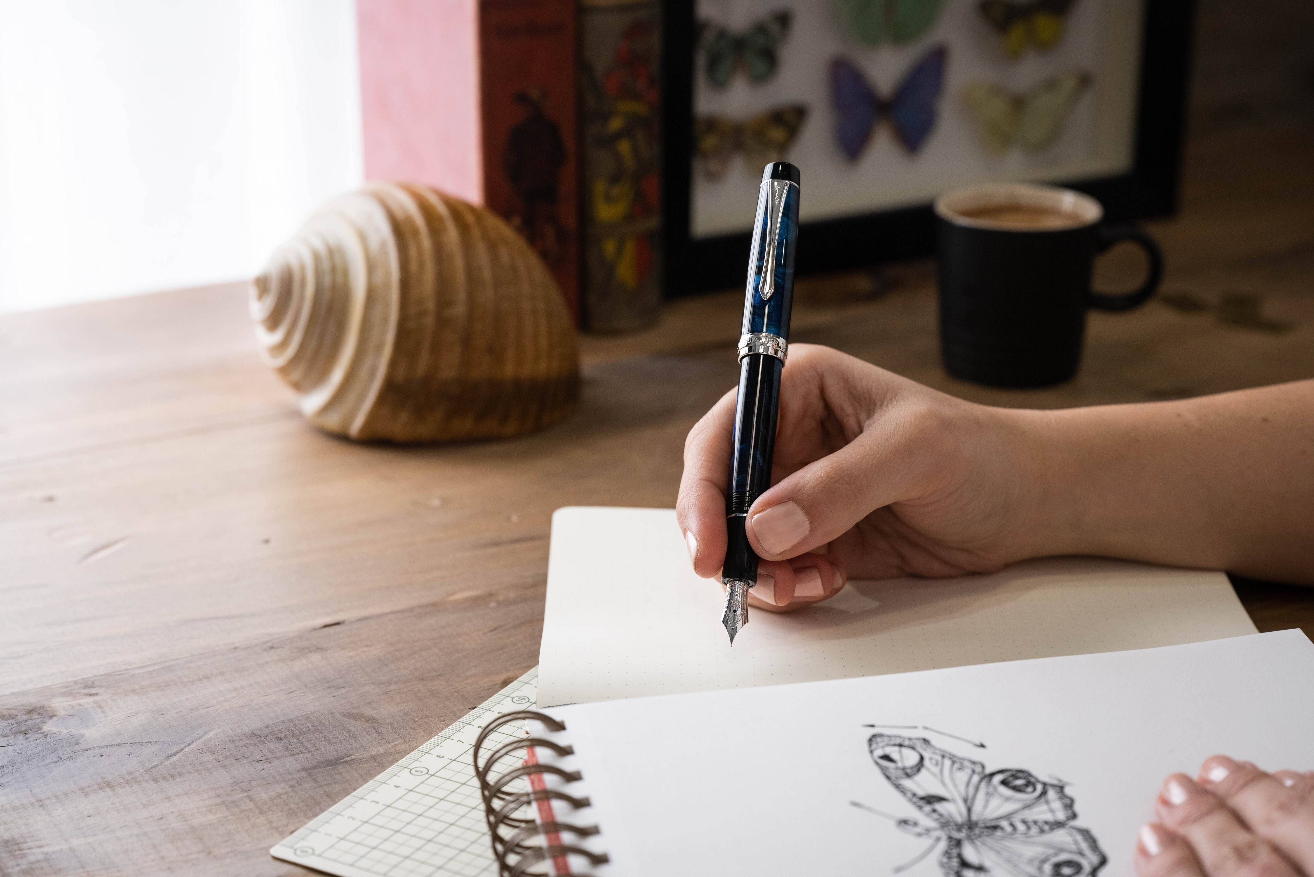 Heritage fountain pen in marble blue about to write on a piece of paper