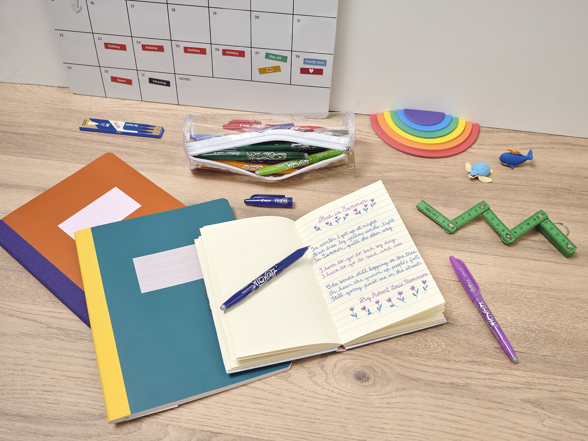 PILOT FriXion Ball pens and open notebook on a study desk, ideas for writing a thank you note.