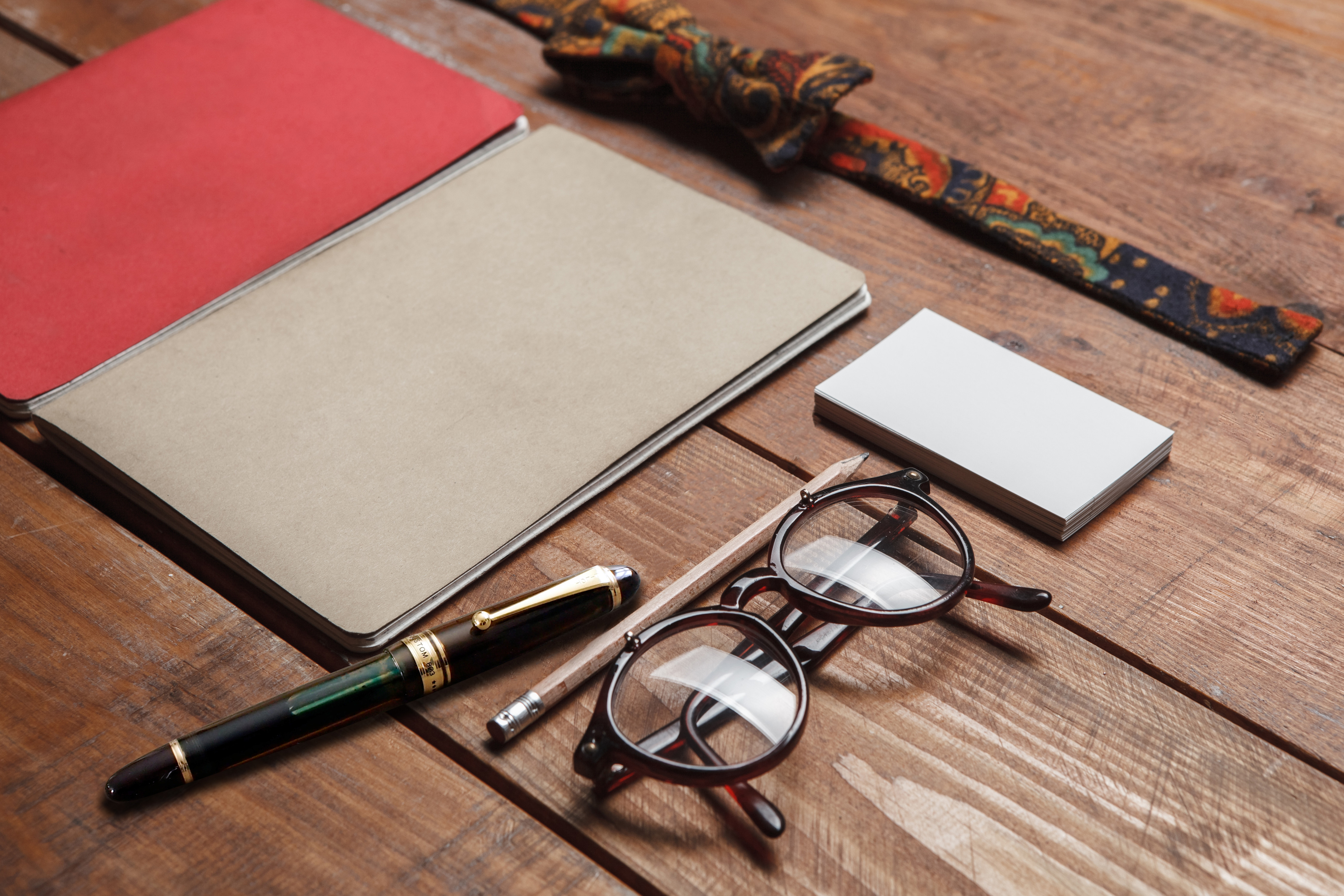 A PILOT Custom 823 Fountain Pen in a stylish flat lay with a notebook, glasses, and accessories, highlighting its timeless craftsmanship