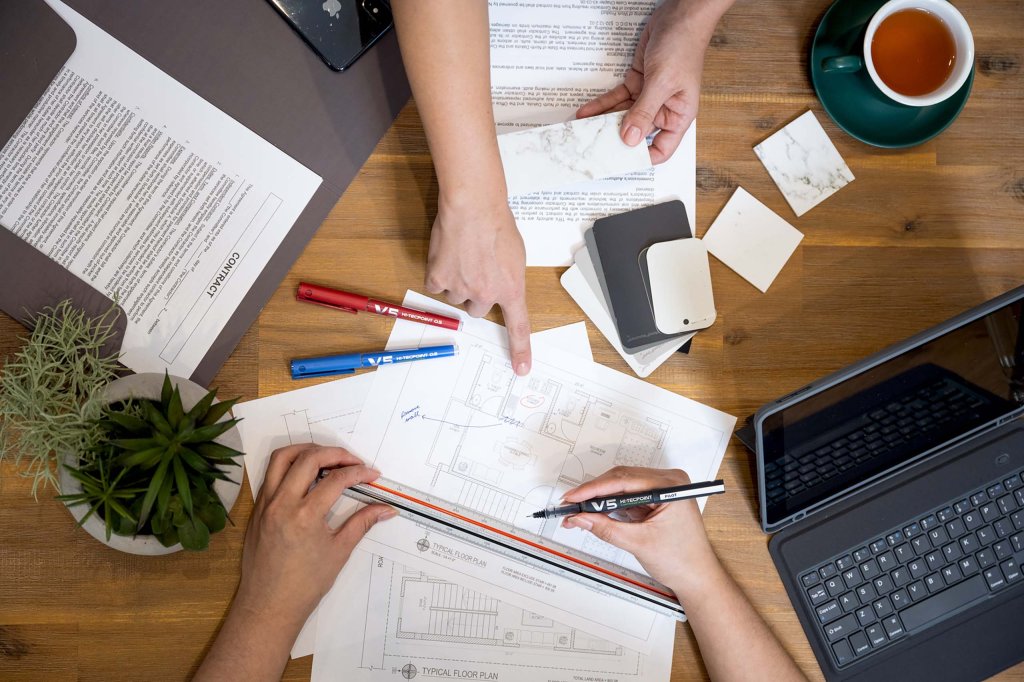 PILOT Pen BeGreen Hi-Tecpoint V5 refillable - Liquid Ink Rollerball pen being used in an office for drafting.