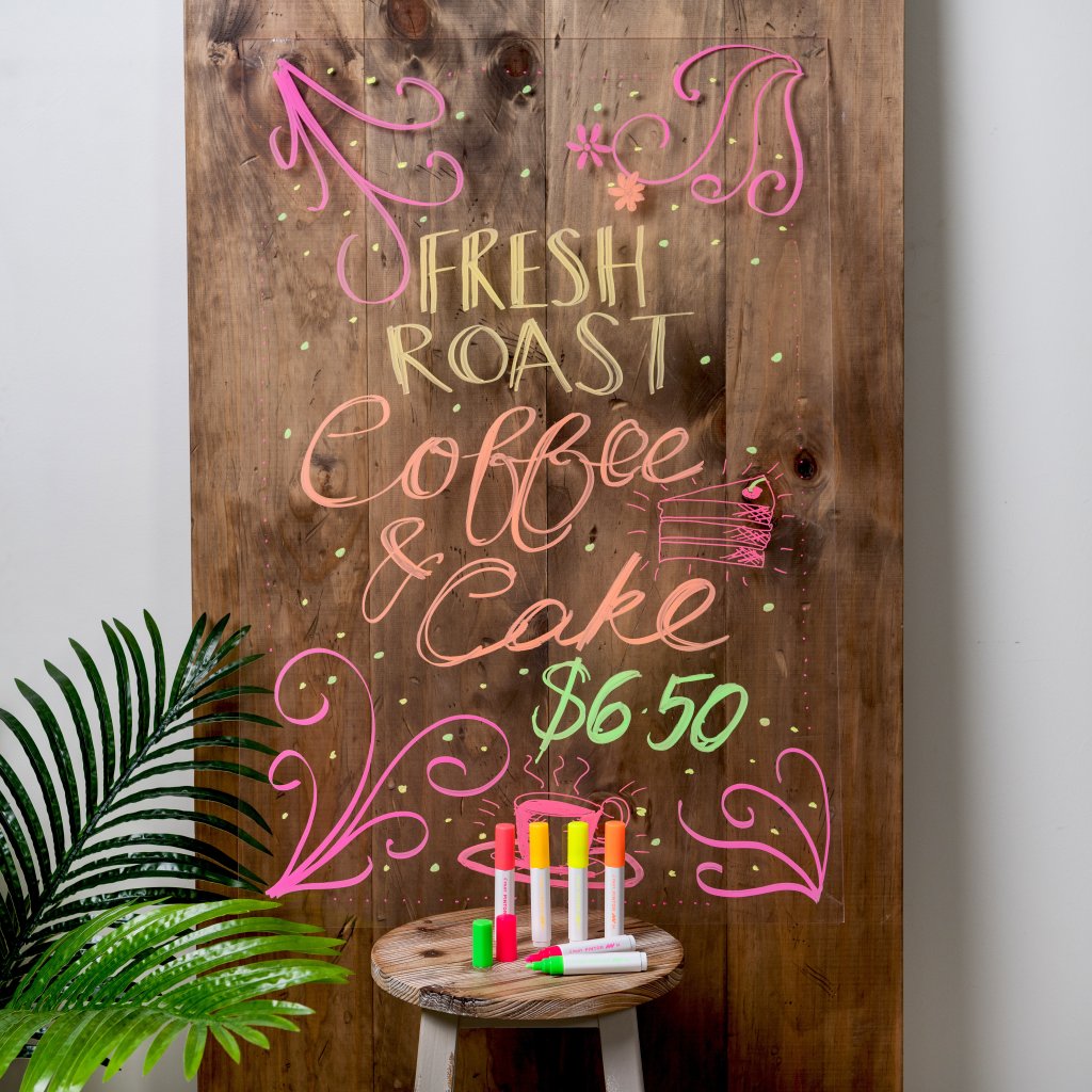 Painting designs and writing for coffee shop sign with Pilot Pen markers.