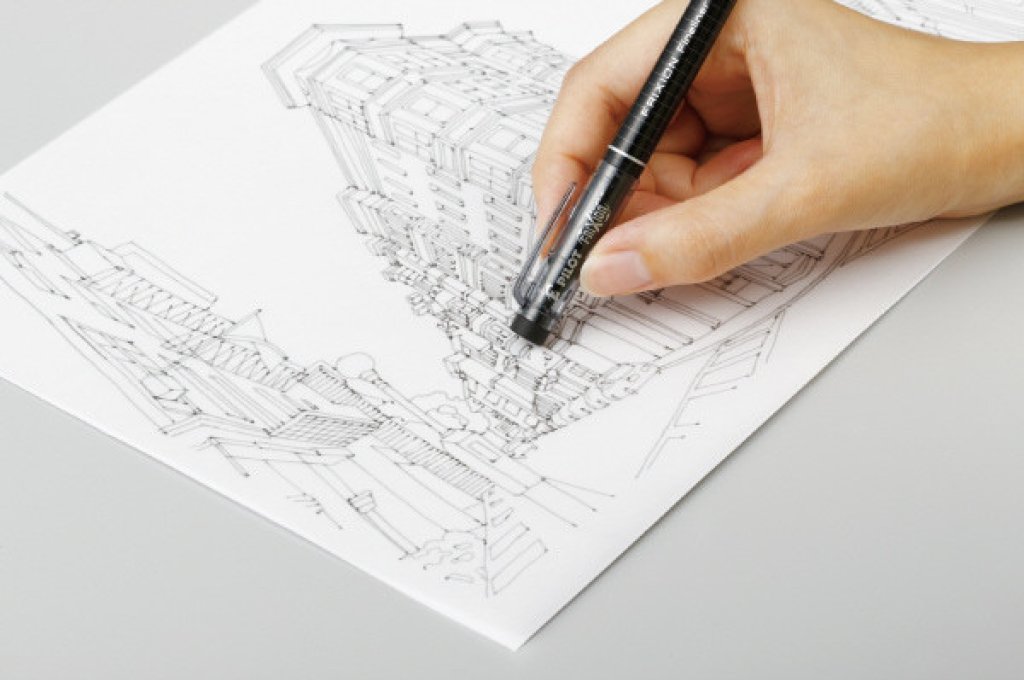 Hand using a black FriXion pen to create detailed architectural illustration, one of the best pens for writing, note taking, and journaling.