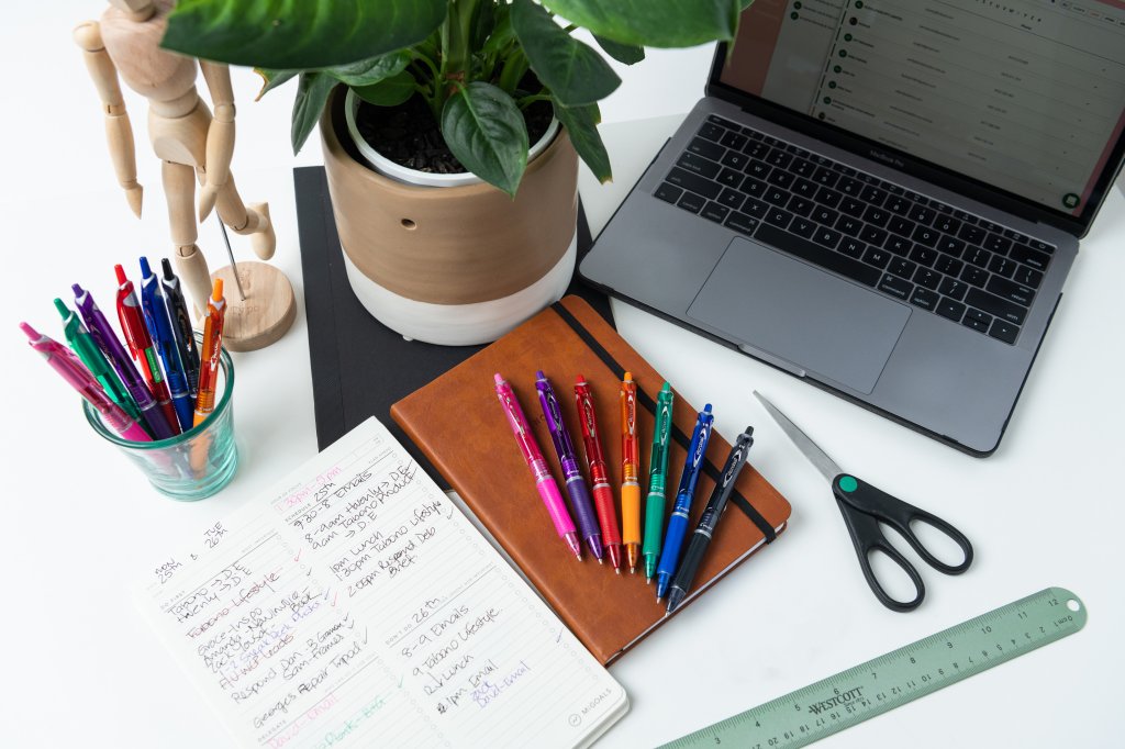 PILOT Pen Professional pens on a desk with note pad, MacBook and other stationary.