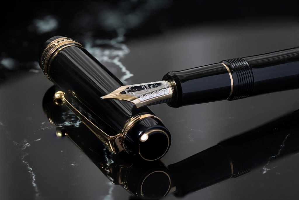 A close-up image of the Pilot CUSTOM 845 fountain pen, showcasing the glossy depth of the urushi lacquer on the barrel and cap. Engraved swirls and Pilot branding adorn the gold nib and trim, highlighting the value, craftmanship and prestige of a fountain pen.