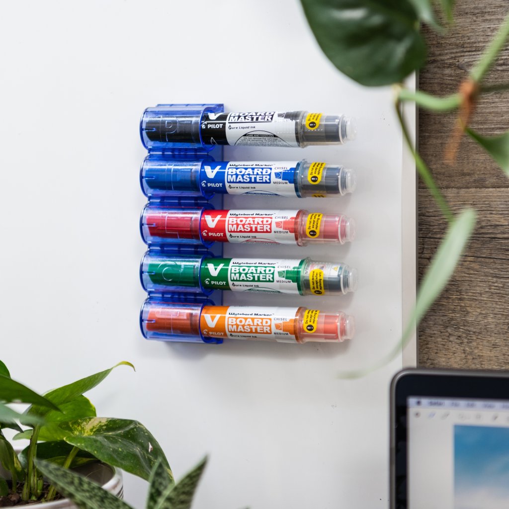 Set of 5 PILOT BeGreen V Board Master whiteboard markers set on an office magnetic board.